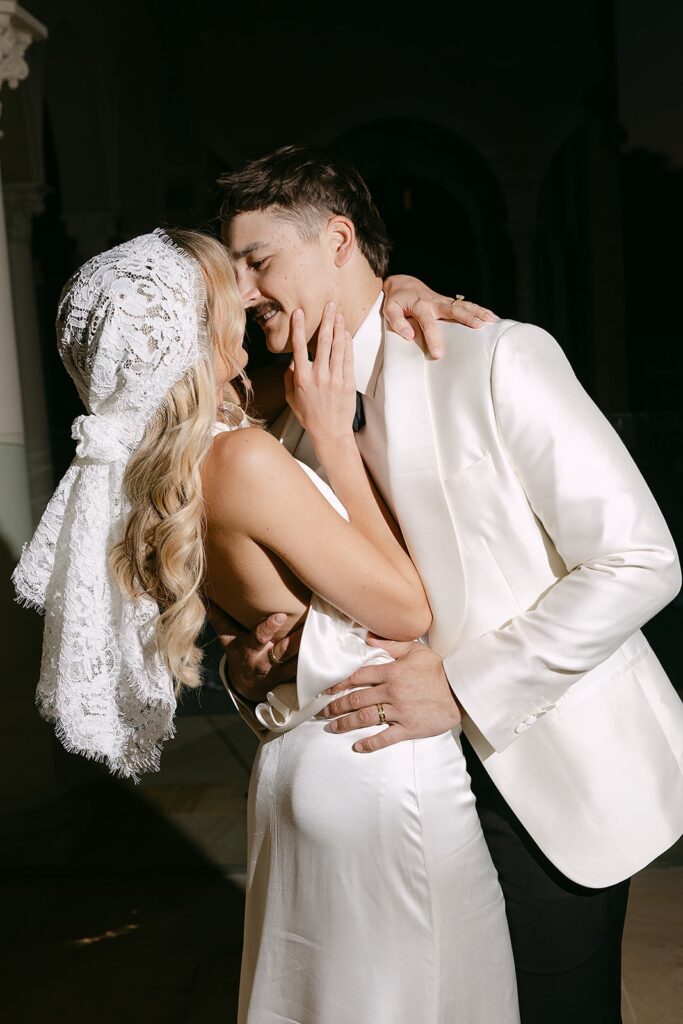 flash photography of couple kissing during wedding reception at alora macedon