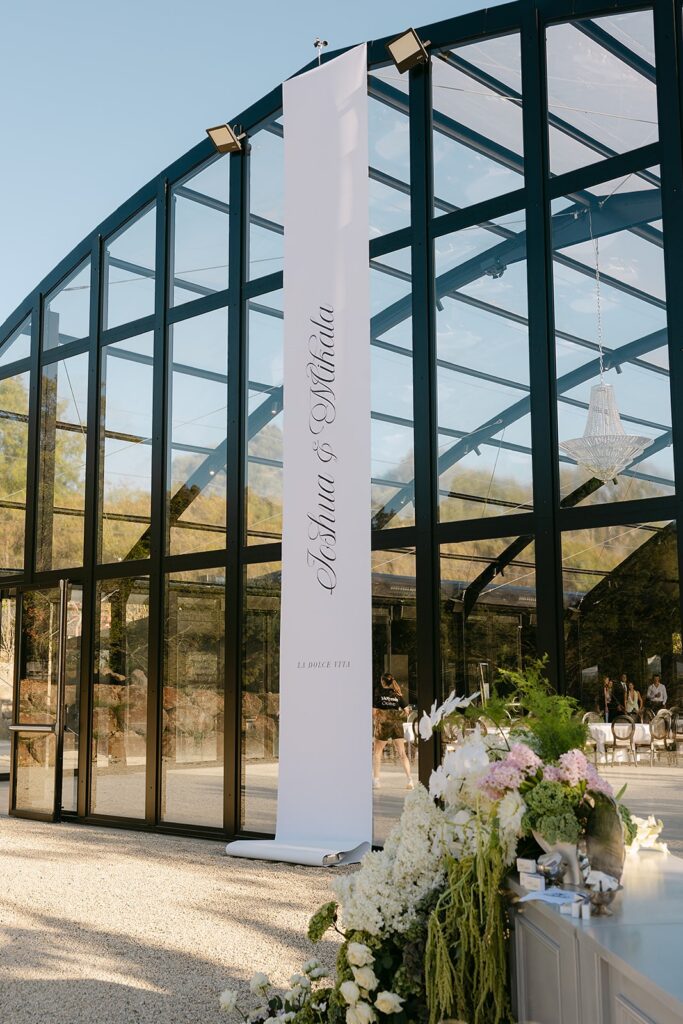 custom wedding ceremony banner installed at alora macedon glass atrium 