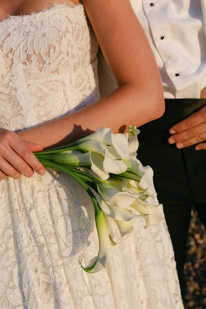 close up editorial shot of bride holding wedding white florals