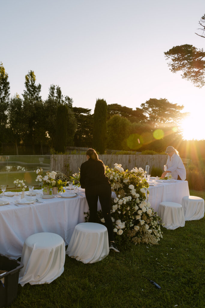wedding stylists setting up outdoor reception at brolga hill estate in Daylesford
