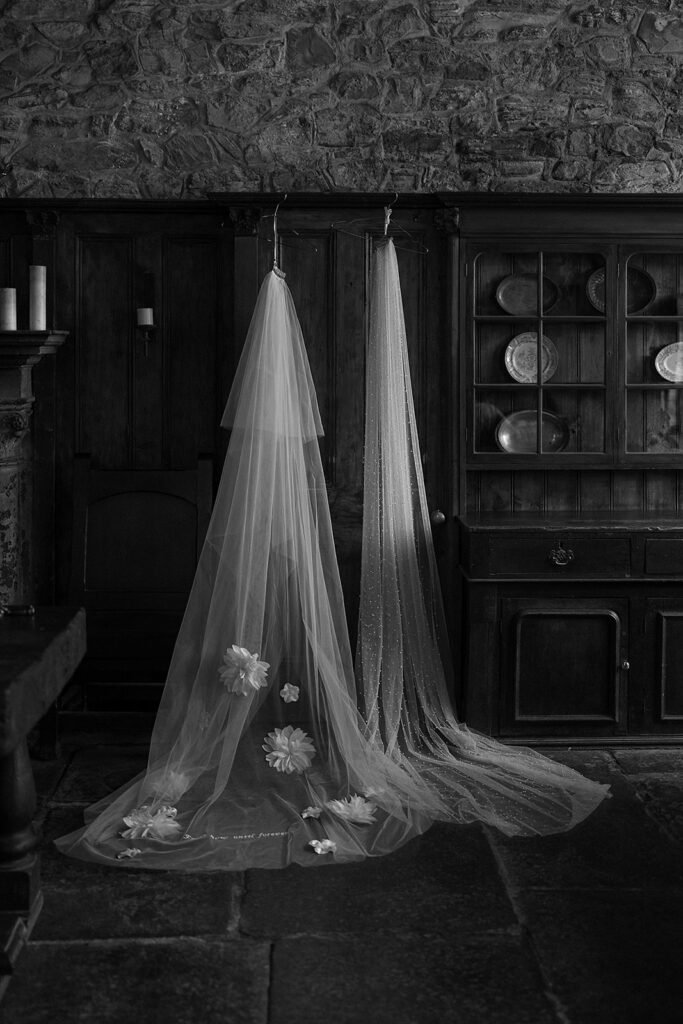 black and white portrait of wedding veil hanging at Montsalvat