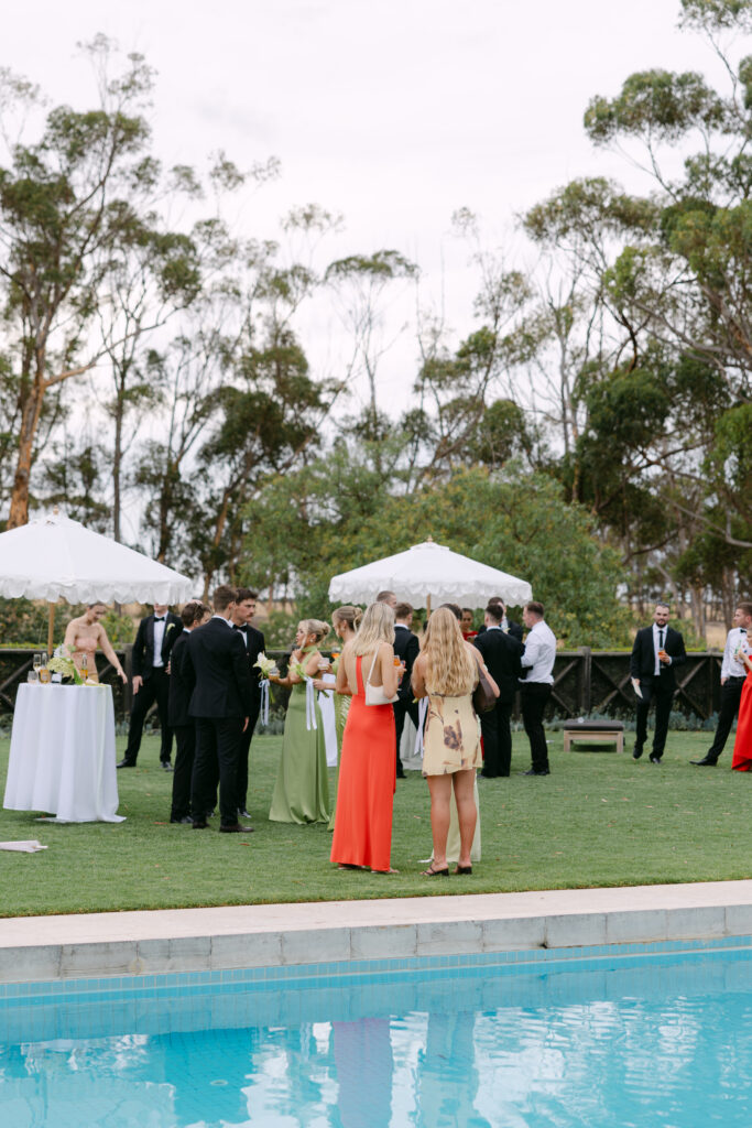 candid portrait of guests mingling next to the outdoor pool at Barunah Plains