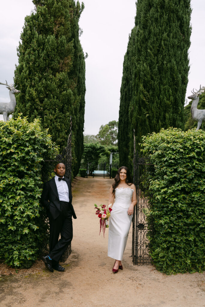 couple leaning on iron gates at Coombe Yarra Valley wedding venue victoria